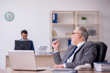 Two male employees working in the office