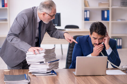 Two male employees and too much work in the office