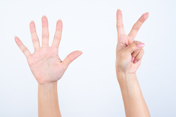 hands with pink manicure over white background pointing up with fingers number seven. 