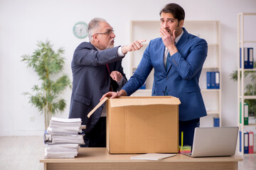 Two male employees in dismissal concept
