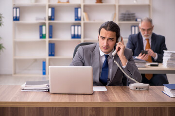 Two employees sitting at workplace