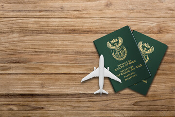 south African passports and toy plane on table