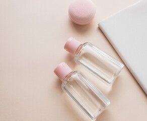 Flat lay composition with cosmetic products and accessories on a pink pastel background. Top view