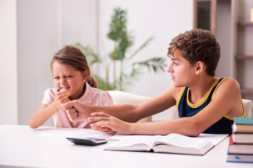 Schoolboy and his small sister staying at home during pandemic