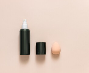 Flat lay composition with cosmetic products and accessories on a pink pastel background. Top view