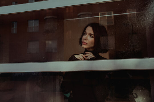 Pensive woman looking out of window