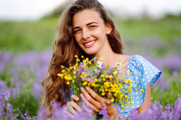 Portrait of beautiful woman in amazing in a blooming field. Nature, vacation, relax and lifestyle....