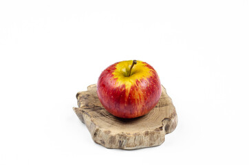 Red apple on a wooden stand. On white background.