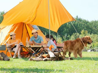 Deurstickers Happy family of four and dog camping out © eastfenceimage