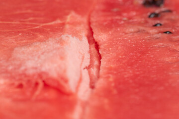 Red watermelon freshly cut with seeds macro.