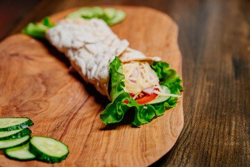 pita with vegetables and chopped cucumbers. vegetarian roll.