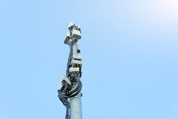 Obraz premium Cellular macro Base Transceiver Station. Telecommunication tower. Wireless Communication Antenna Transmitter, many wires to connect the communication section.