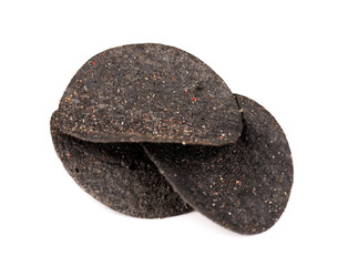 Black potato chips isolated on white background. Black chips with activated charcoal and red pepper.