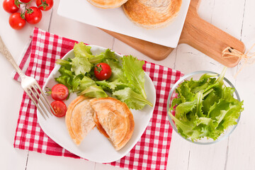 Puff pastry filled with tomato and mozzarella cheese.