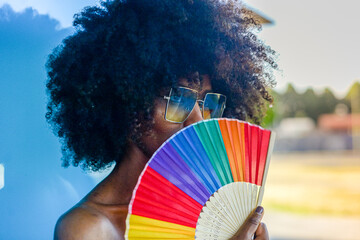 person with rainbow colored fan