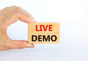 Live demo symbol. Concept words 'live demo' on wooden blocks on a beautiful white background. Businessman hand. Copy space. Business and live demo concept. - obrazy, fototapety, plakaty