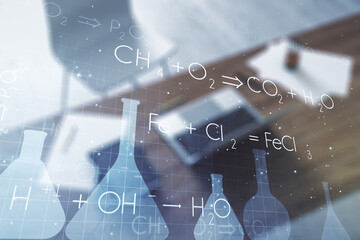 Creative chemistry concept and modern desktop with computer on background. Multiexposure