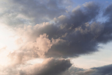 Beautiful clouds in the sky. Evening warm light through the clouds.