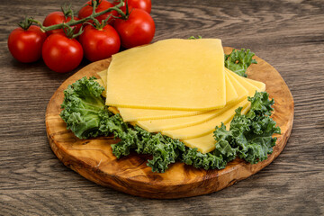 Sliced Gauda cheese over board