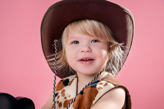 2 year old toddler playing make believe cowboy