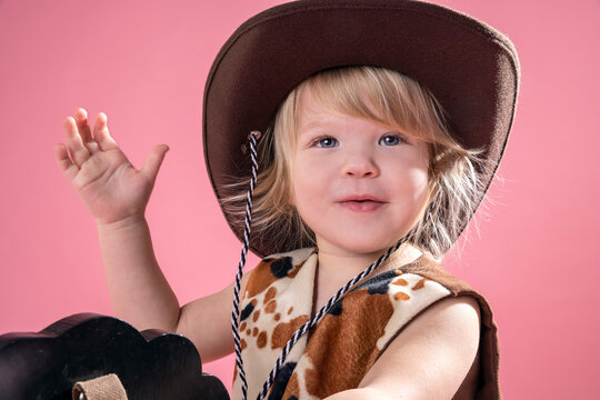 2 year old toddler playing make believe cowboy