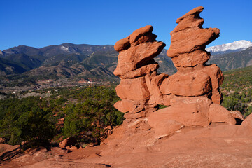 View of Pikes peak through the hole in the Siamese Twins red rock formation in the Garden of the Gods park in Colorado Springs, Colorado, United States