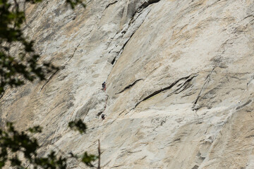 Climbers on the face of El Capitan about half way up the rock.