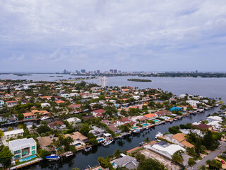 Beautiful cinematic aerial view of the Miami luxurious suburbs with boats near the ocean