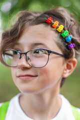 teenage girl with glasses with colorful rainbow hair clips, LGBTQ theme