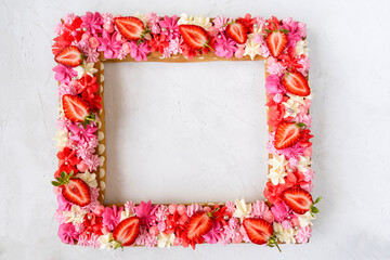 Summer cake frame with strawberries and cream. Delicious beautiful dessert border.