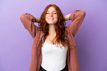 Teenager redhead girl over isolated purple background laughing