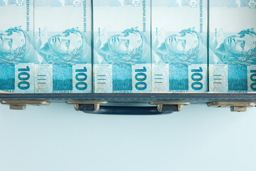 Brazilian money stacked in a suitcase, Empty space for text, Business and financial concept.