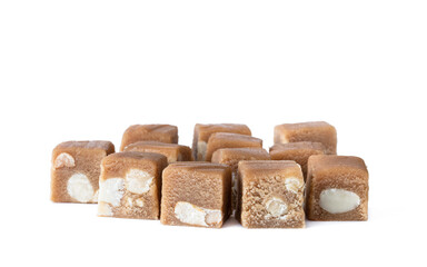 cubes of toffee fudge with monkey nuts isolated on white
