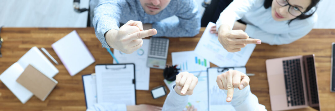 Furious businessmen look up and show the facts