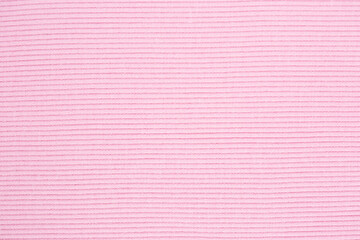 Fototapeta premium Pink knitted background. Knitted texture. Knitting pattern of wool. Knitting. Texture of knitted woolen fabric for wallpaper and an abstract background