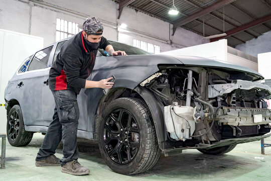 Man polishing car in workshop