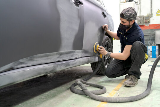Man buffing car in service