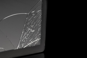 The broken tablet screen covered with many cracks