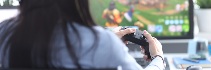 Woman with remote control in hands playing video game