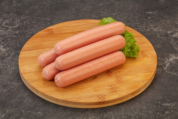 Tasty meat sausages over board