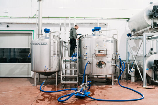 Brewer checking up lauter tun at work in beer factory