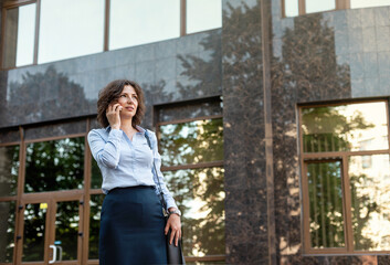 Beautiful business woman is talking on a smartphone.
