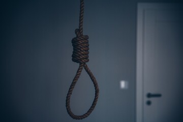 Rope with loop or knot. Symbol of suicide, death.
