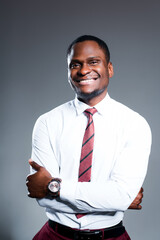 Happy african american businessman in white shirt smiling with arms crossed on chest