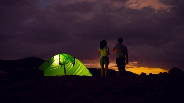 footage 50p frame rate of adventurous couple are setting up campfires and enjoying the beauty of nature.
