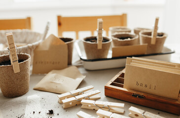 Seeds, peat pots, gardening tools on linen fabric background. Ready for plant