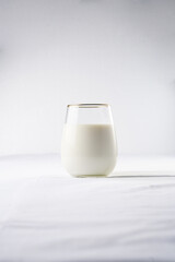 A glass of milk on the white table cloth