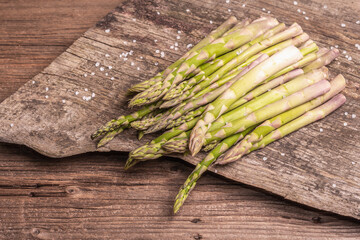 Ripe asparagus ready for cooking on vintage wooden stands