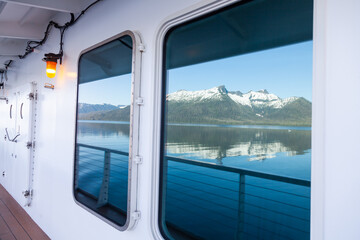 Fototapeta na wymiar Landscape reflection in window of ship