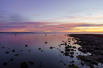 Summer sunset over stone beach in Helsingborg, Sweden.